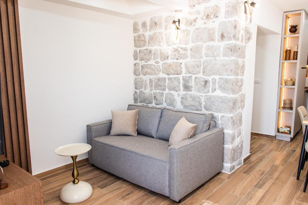 Modern living room with stone wall feature and designer sofa