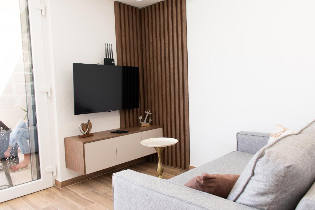 Living room with flat-screen TV and walnut feature wall